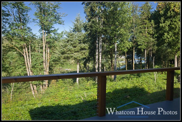 View to Friday Creek woodland framed by deck railing